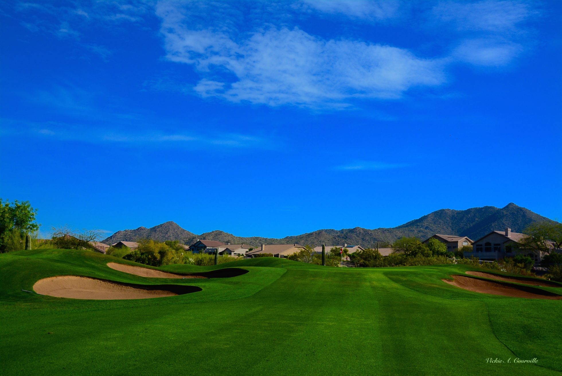 view of the greens and mountains